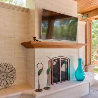 Backyard patio fireplace with TV