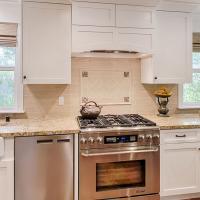 Kitchen with custom vent hood over stove